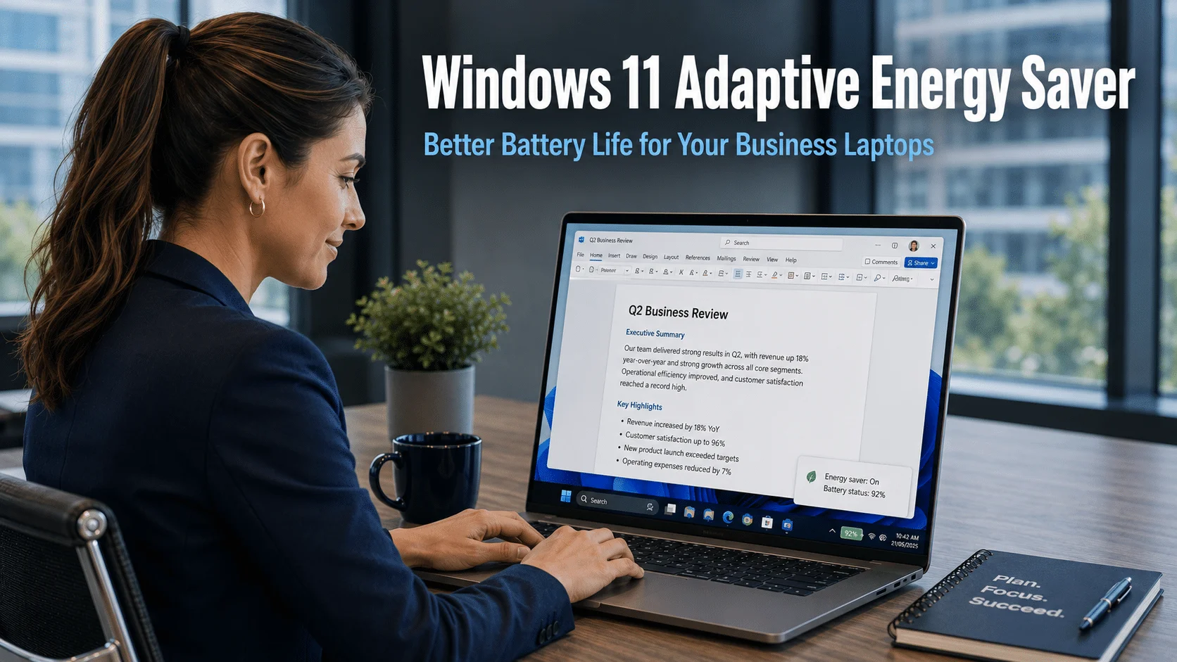 Business professional working on a Windows 11 laptop in a modern office with a battery status indicator showing strong remaining charge, representing the Windows 11 adaptive energy saver feature