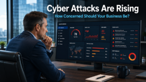 Business owner reviewing a cyber security threat alert on a monitor in a modern office, representing the growing risk of cyber attacks for businesses