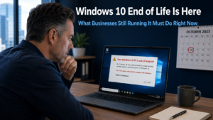 Business owner looking urgently at a Windows 10 laptop showing an end of support warning notification, representing the Windows 10 end of life deadline that has now passed for businesses