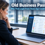 Business professional reviewing a password manager and account audit on a laptop in a modern office, representing the security risk of old business passwords and the importance of reviewing and updating business account credentials